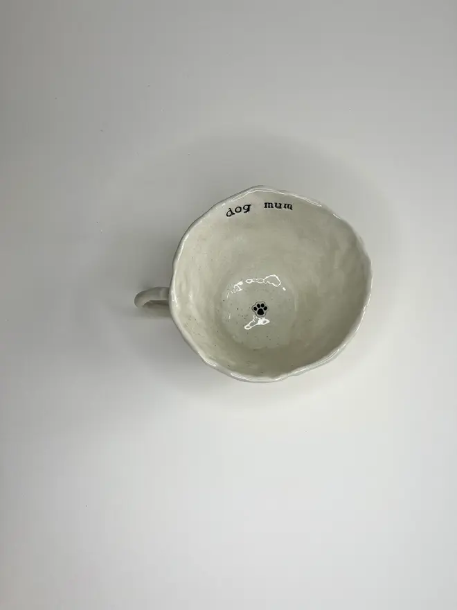 'Dog Mum' Favourite Pawprint Mug, placed on table with pawprint inside it. 