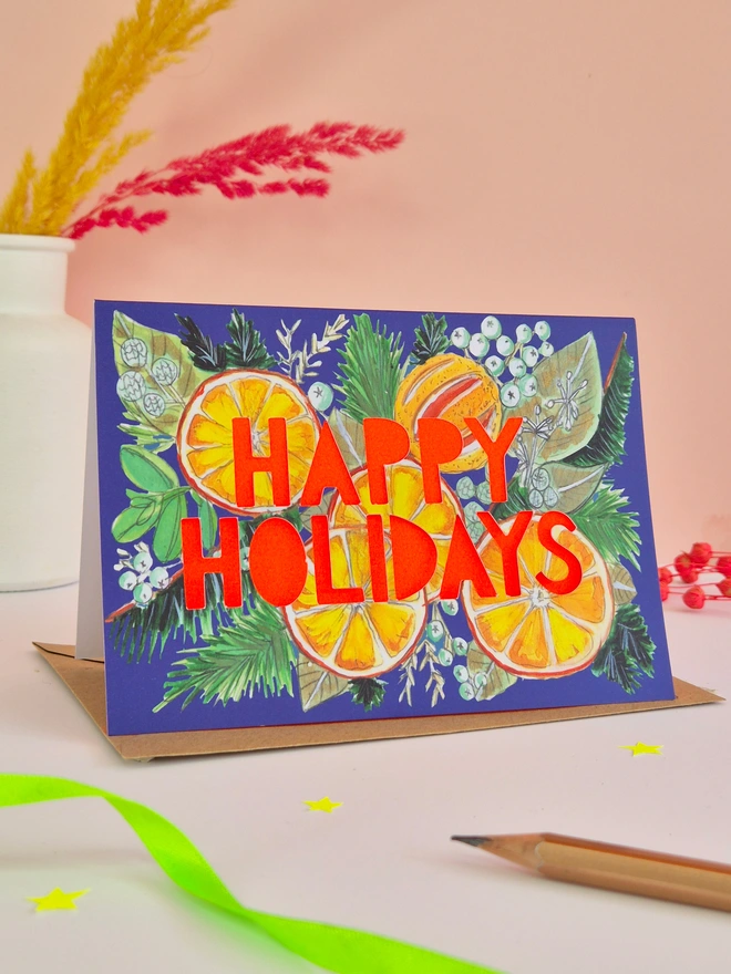 Orange Illustration Christmas Card with Happy Holidays Paper cut text with neon red backing paper 