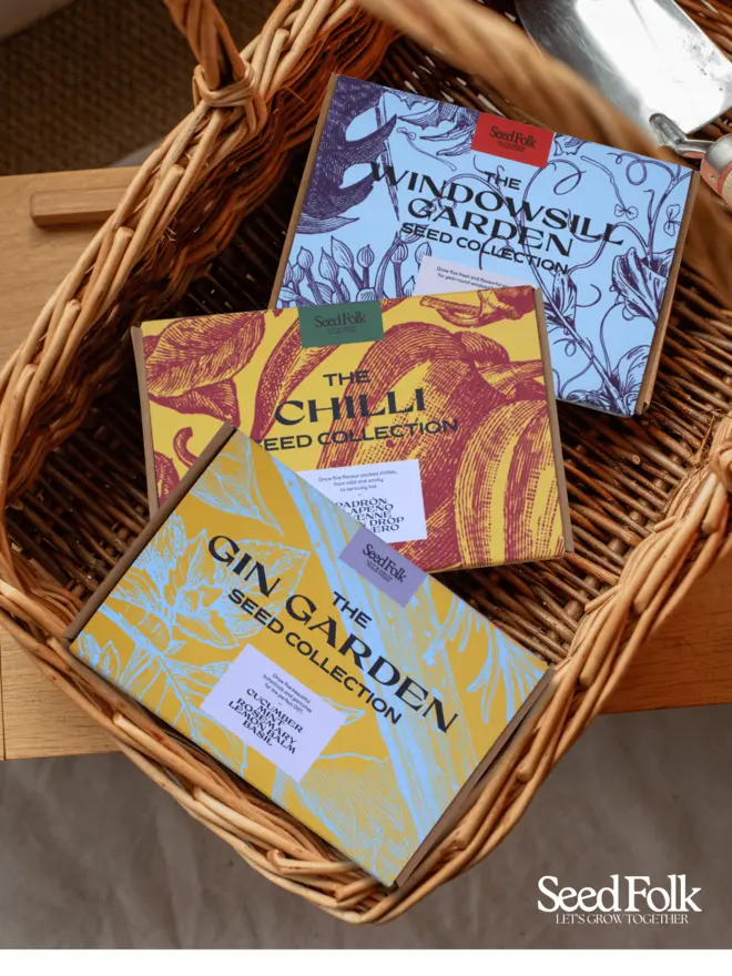 The Gin Garden, The Chilli Collection and The Windowsill garden, seed collection kits all photographed in a decorative basket.