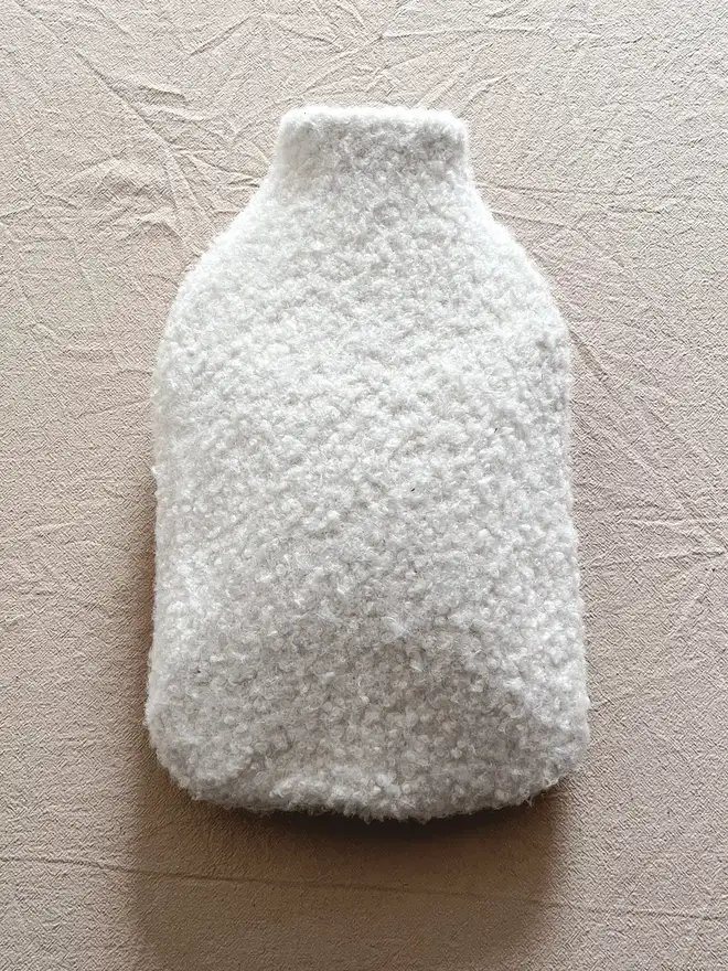 hot water bottle with white wool cover