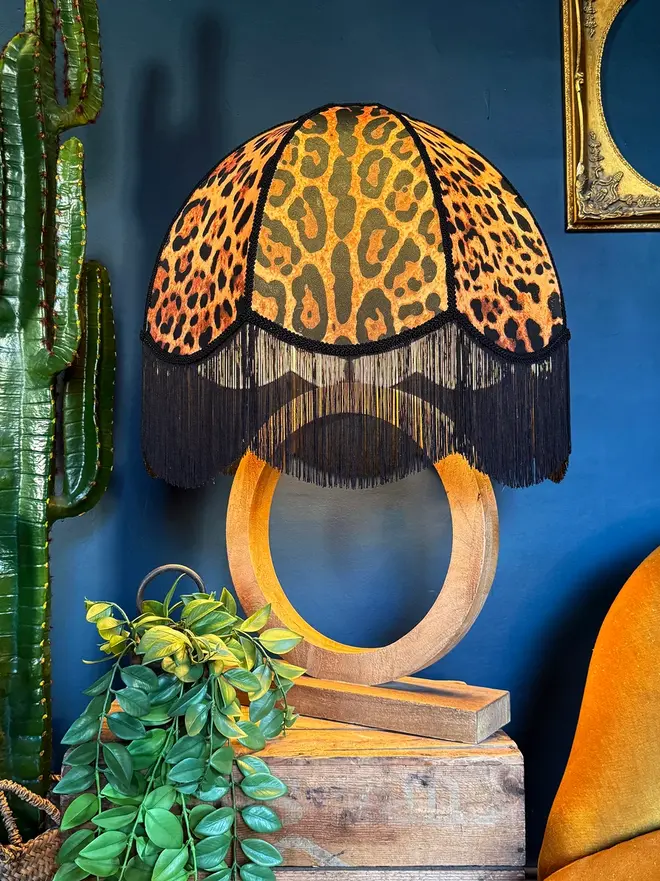 Vintage Fringed Dome Lampshade In Leopardess, in a room. 