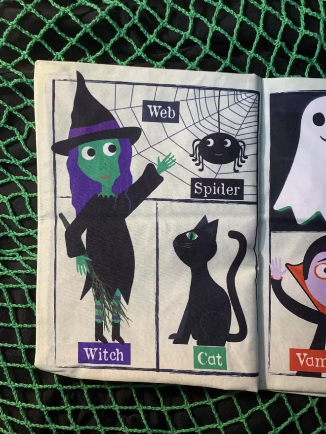 Halloween crinkly newspaper with with and spider in a web and a black cat