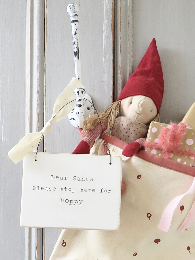 Chalky white painted wooden hanging sign with personalised Dear Santa message