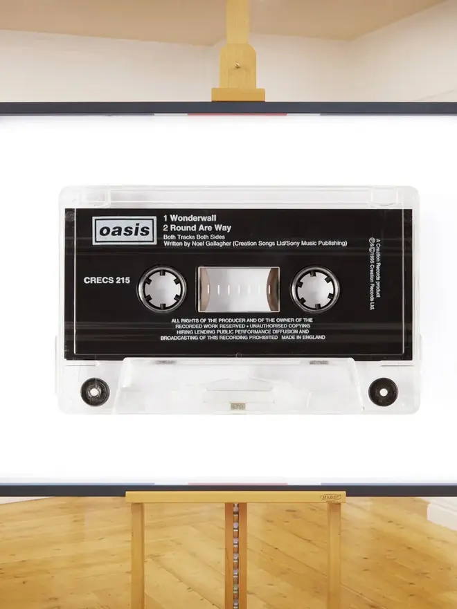 oasis wonderwall cassette tape print. framed print on easel in gallery.