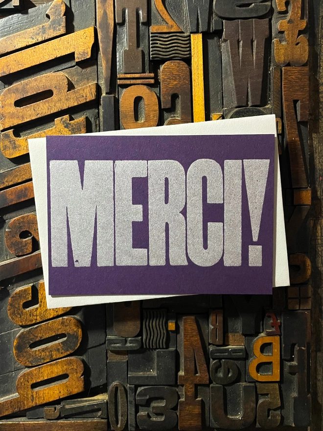 Merci! A beautiful typographic letterpress postcard printed with metallic silver inks printed on rich thick  colourful card with a luxury matching envelope; ideal to send a thank you note to a friend or loved one.