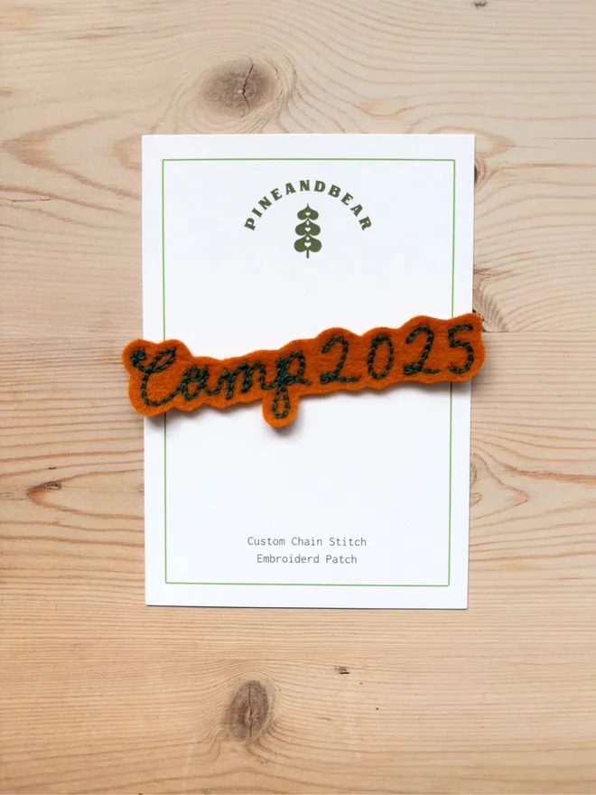 Personalised Chain Stitch name patch in tan and green on a white presentation card