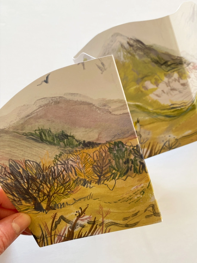 Esther kent illysrated and handcut greetings card, showing painted hilly landscape in greens and purple