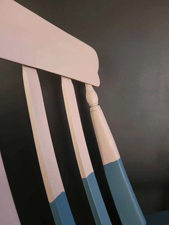 Close up fo the pink and blue rocking chair, plaster pink and dusty blue