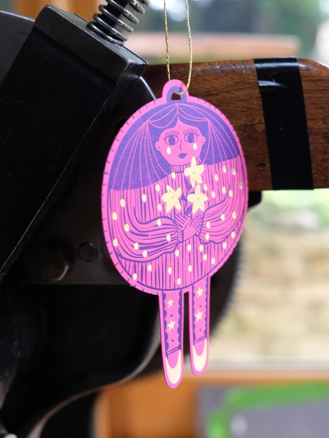 Card pink bauble lady decoration printed in blue with gold dots and flowers. 