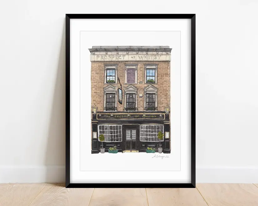 Wapping Prospect of Whitby Giclée Print (Unframed), a print of a pub sitting in a frame on a wooden surface against a plain backdrop. 