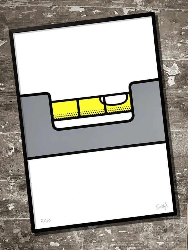 Screenprint of a spirit level, at an angle with the bubble up one end. Yellow, grey and black ink on white paper - shown in a black frame and laid on untreated floorboards.