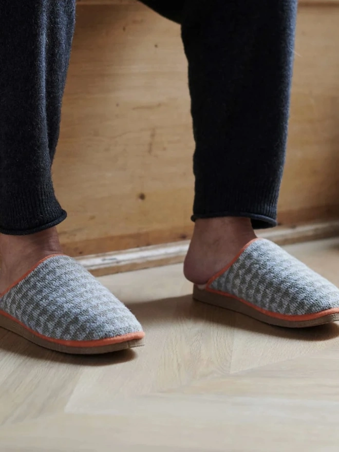 Lambswool & Sheepskin Slippers, a person wearing a pair of colourful lambswool and sheepskin slippers. 