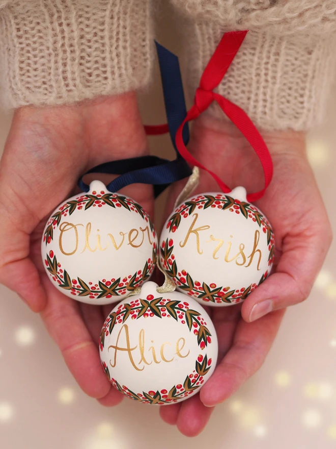 Three hand painted and personalised ceramic baubles