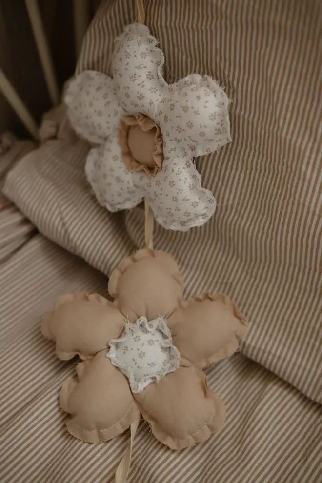 Daisy Flower Garland Decoration, a hanging colourful daisy flower garland sitting in a child's bedroom. 