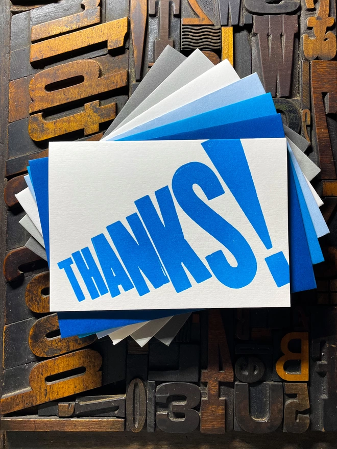 Thanks! A vibrant thank you typographic letterpress card with deep impression print using fluorescent blue, with a range of colourful envelopes. Slight print variations adding to the style anding to the charm of this handmade greeting card.