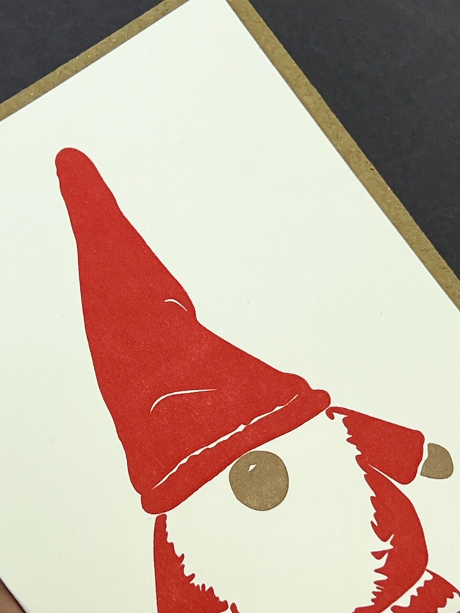 Close up of the letterpress printed Gonk with a red hat