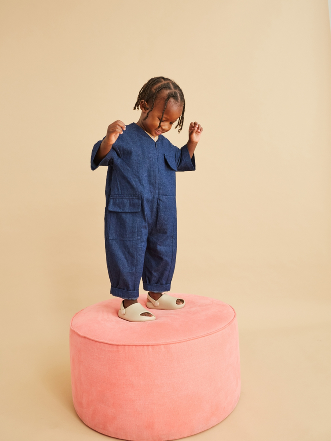 oversized kids and toddler denim overalls standing on pink stool from pavement store walthamstow 