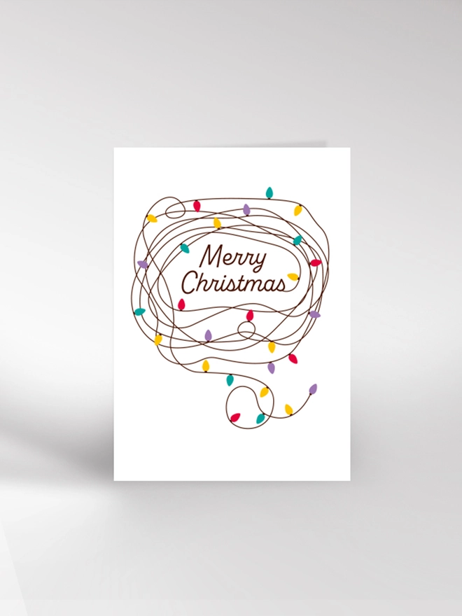 Contemporary illustrated Christmas card of tangled fairy lights reading Merry Christmas