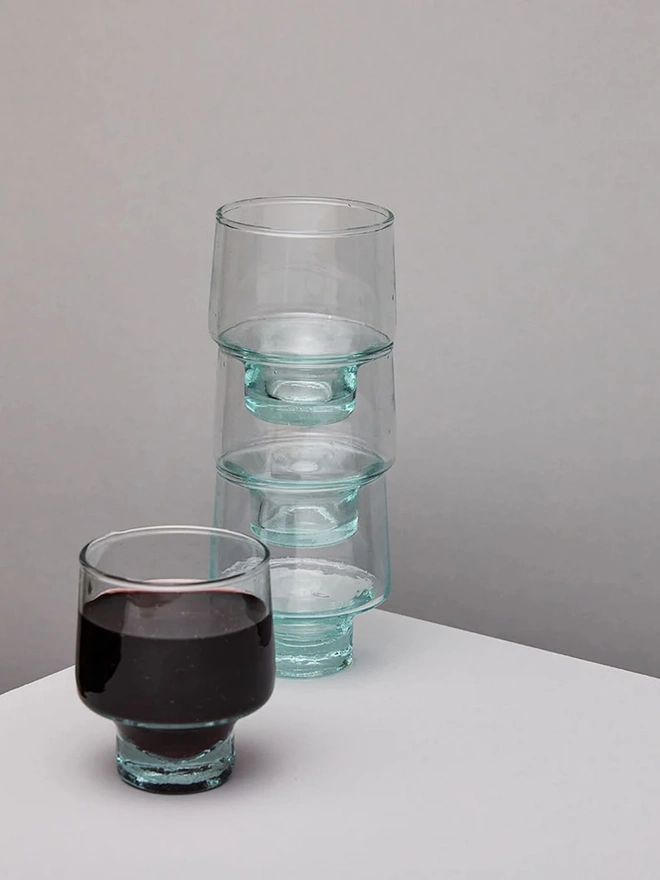 Low Wine Glasses (Set Of 1 Or 4), a set of wine glasses sitting on a plain counter top against a white backdrop. 