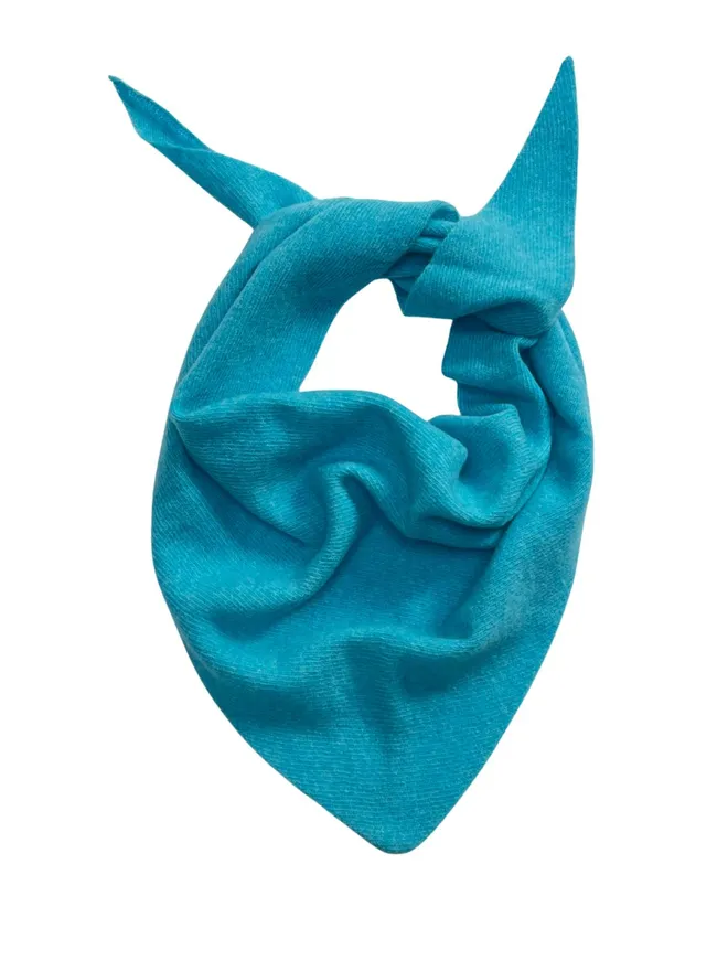 Turquoise triangle scarf shown folded on a white background