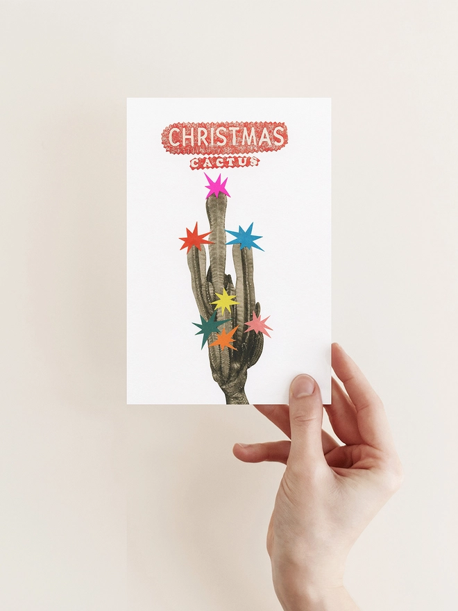 A vibrant, retro Christmas card featuring a tall cactus decorated with colourful stars.