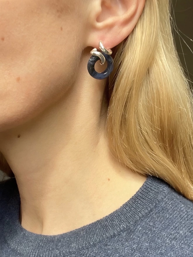 A silver and blue sodalite hoop earring