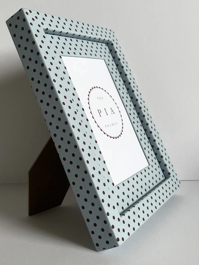 Blue & Burgundy Pembroke Dot Frame, a colourful dotted frame sitting on a plain white surface. 