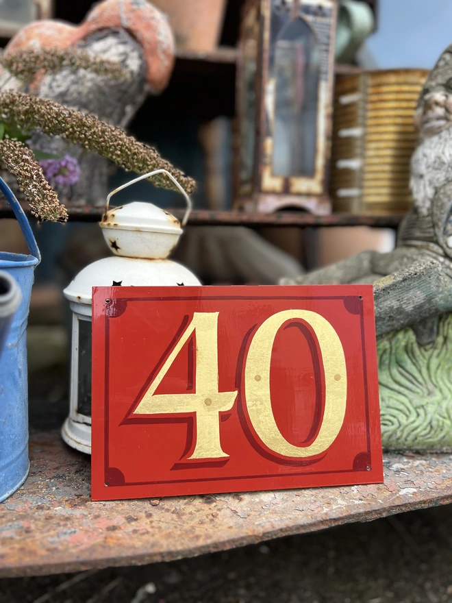 Gold leaf '40' on an orange-red background with deeper orange-red shade and border details.