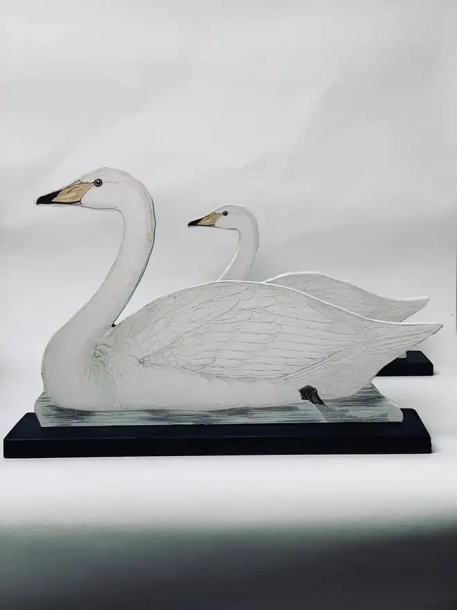 A pair of decoy style swans