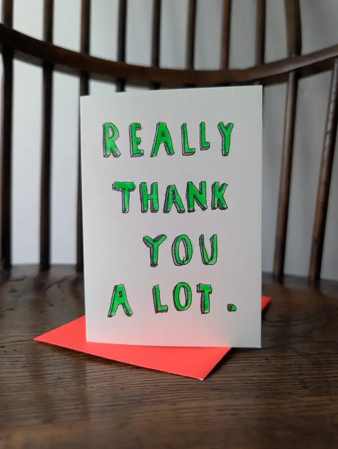 a card that says really thank you a lot hand finished with fluorescent green paint