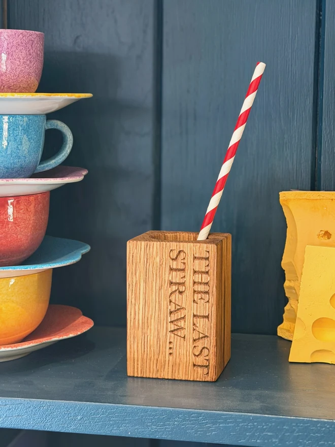 Stripy straws in a straw cup with engraving that says It's the last straw...