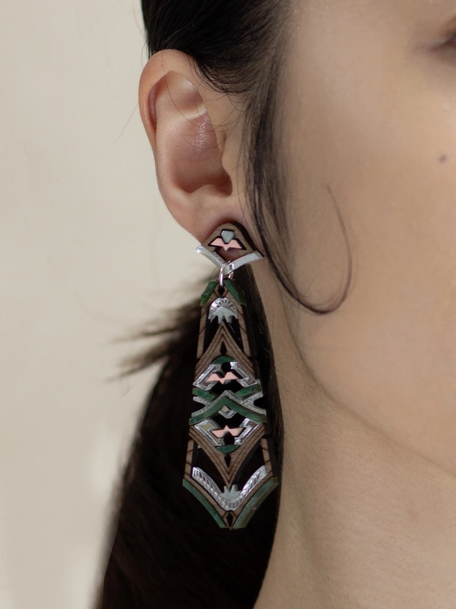 laser cut earrings on ear with neutral background