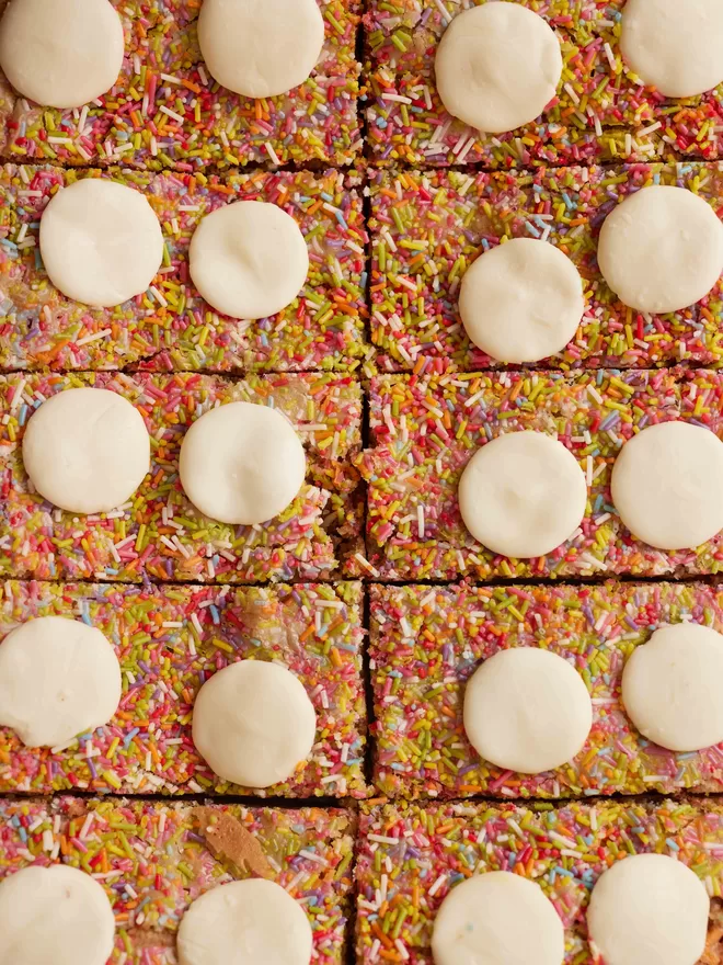 Birds eye view, close up of ten Funfetti blondies with sprinkles and white chocolate 