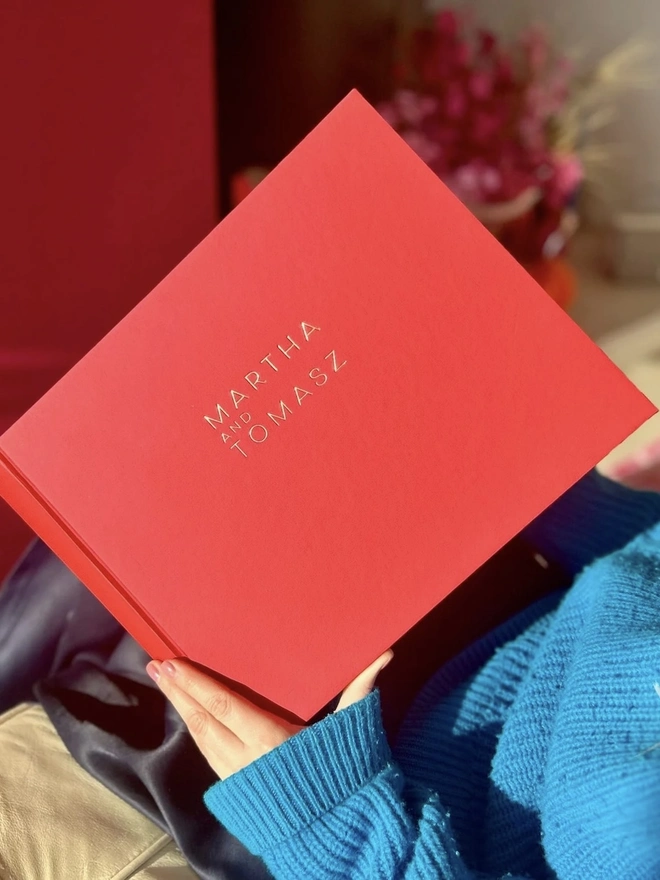 Bold & Beautiful Personalised Guest Book, woman holding guest book open. 