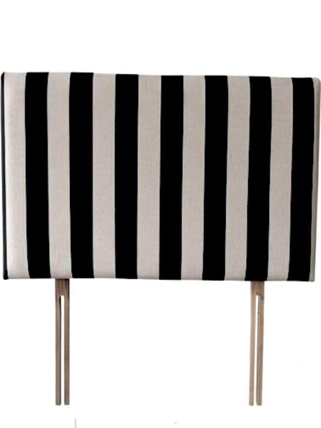 Hand Painted Upholstered Linen Headboard In Stripe Print, a black striped headboard sitting against a white background. 