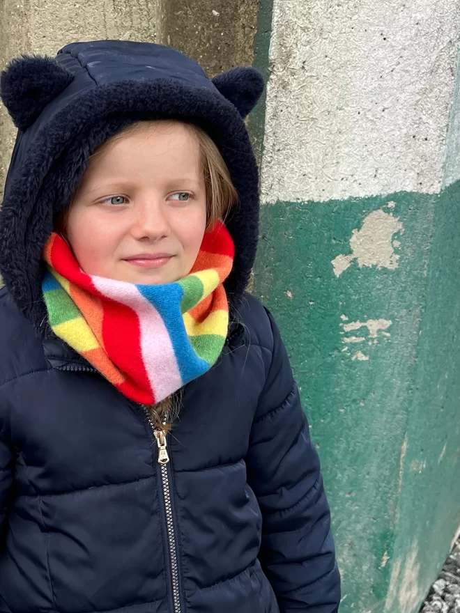 Rainbow knitted snood being worn by child
