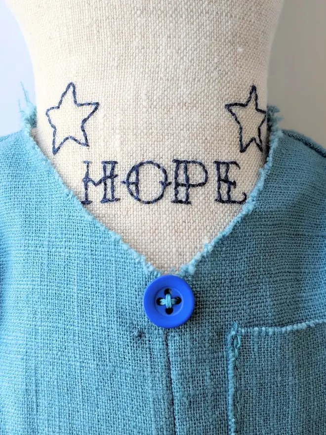 tattooed bear doll. a cream linen bear doll with embroidered neck tattoos and a blue waistcoat.