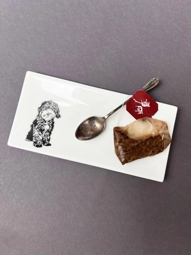 Cockapoo paw trinket tray with a used tea bag and spoon
