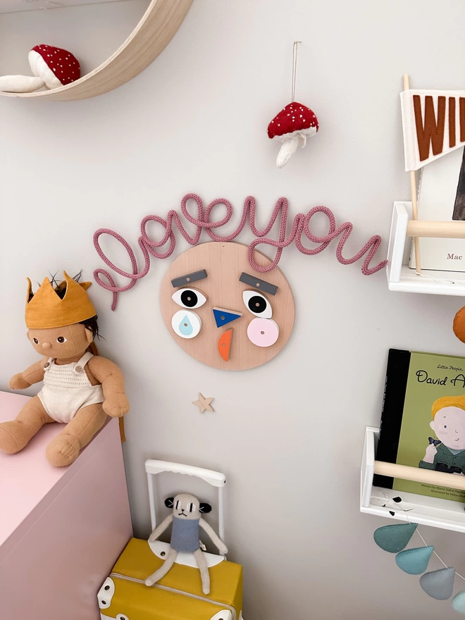 "I love you" wall art sign hanging up in a nursery, for a newborn baby. 