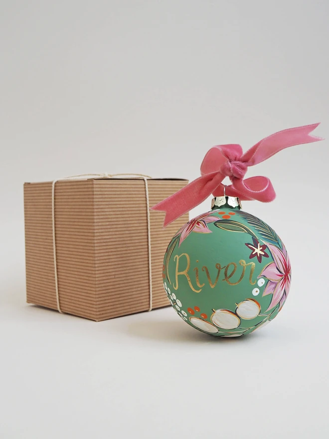 Green personalised bauble with pink and white floral details