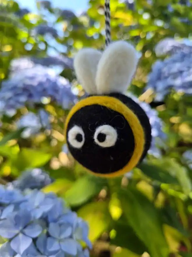 Felt Bumble Bee hanging in the garden.