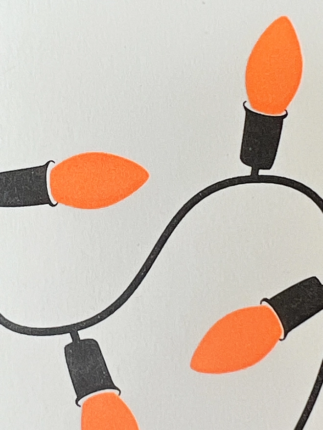 Close up of the neon orange lights letterpress printed on a little note card