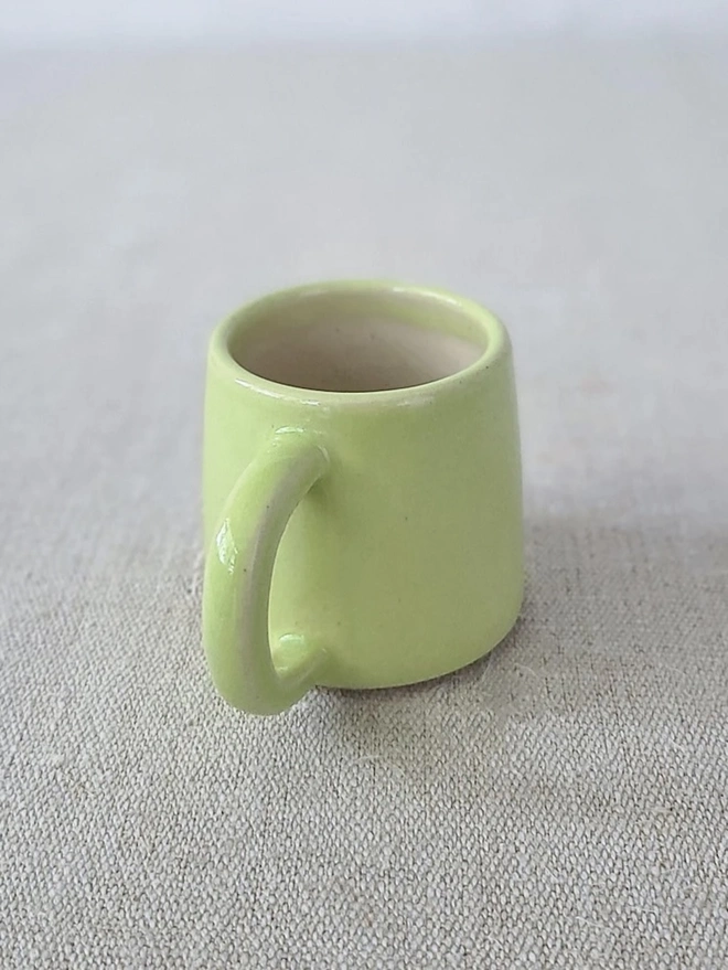 Classic Ceramic Espresso Mug, a colourful ceramic espresso mug sitting on a plain surface against a white backdrop. 