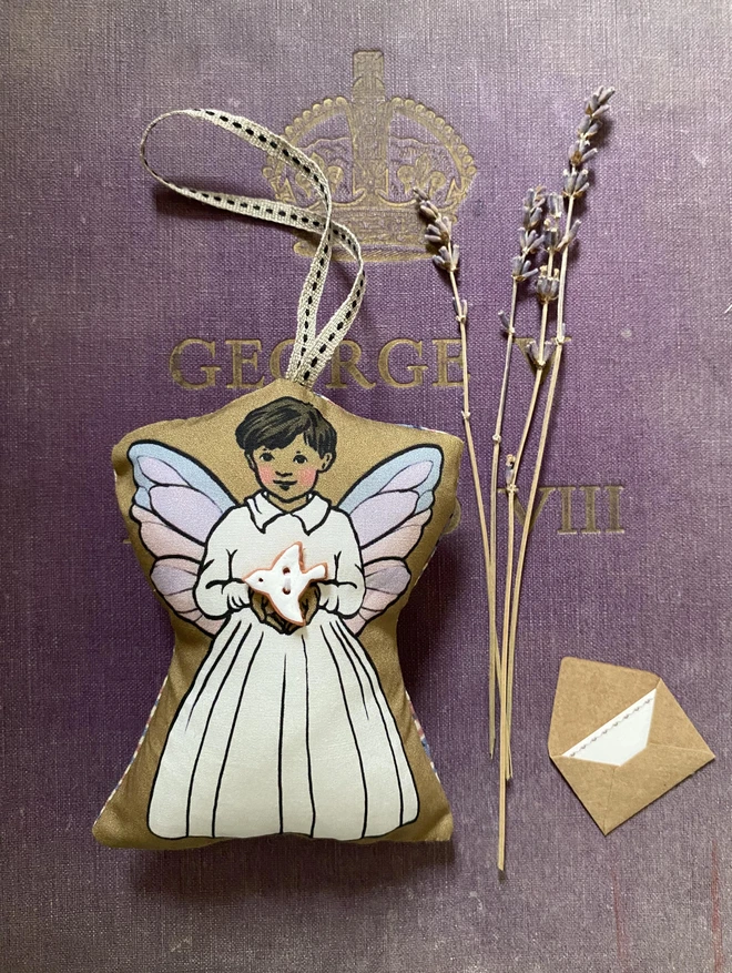 asian tooth fairy boy decoartion holding a peace dove button with a ribbon for hanging