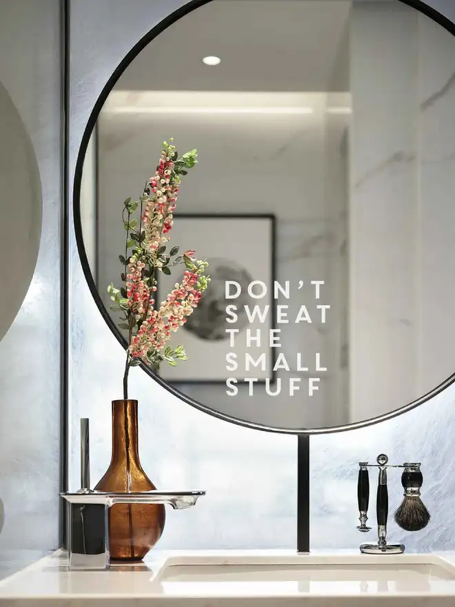 Vinyl decal reading “Don’t Sweat the Small Stuff” applied to a bathroom mirror as a gentle daily reminder.