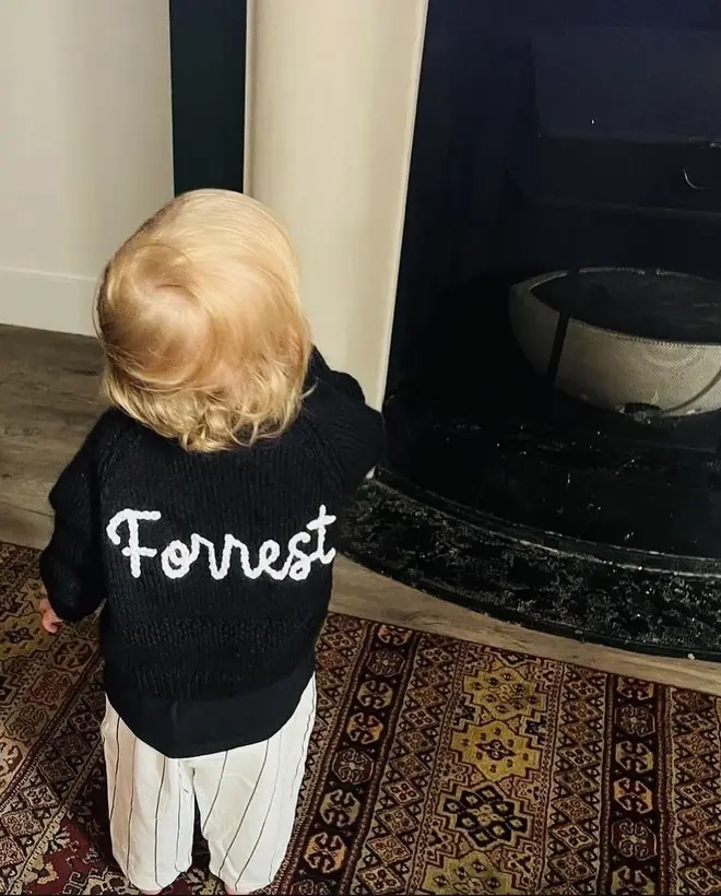Personalised Cardigans, a black cardigan with a personalisation that reads: 'Forrest'. 