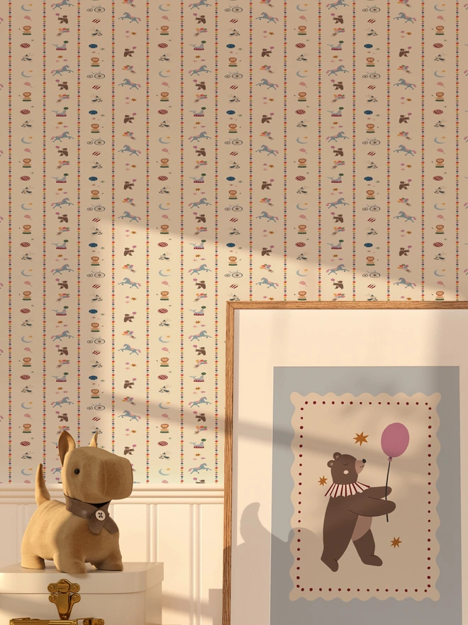 wall paper in stripes of images with circus themed animals and circus items, a picture is leaning against the wall and a teddy bear