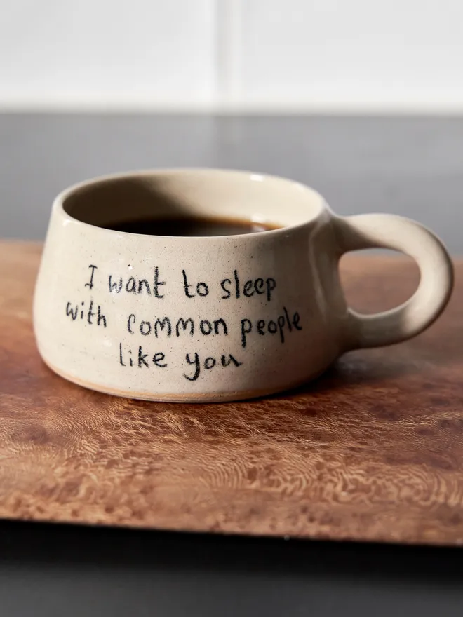 Cream ceramic mug with the words 'I Want To Sleep With Common People Like You' written on it 
