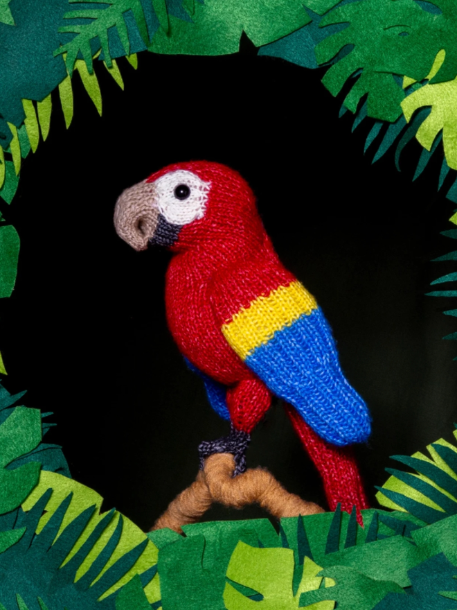 Macaw Knitting Kit. A knitted red macaw.