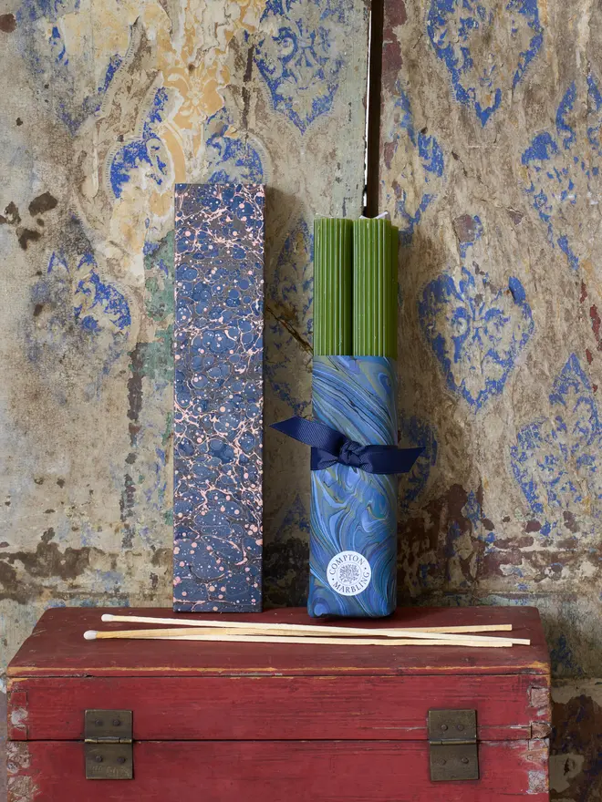 Scalloped fern green Candles with a box of long blue marbled matchbox